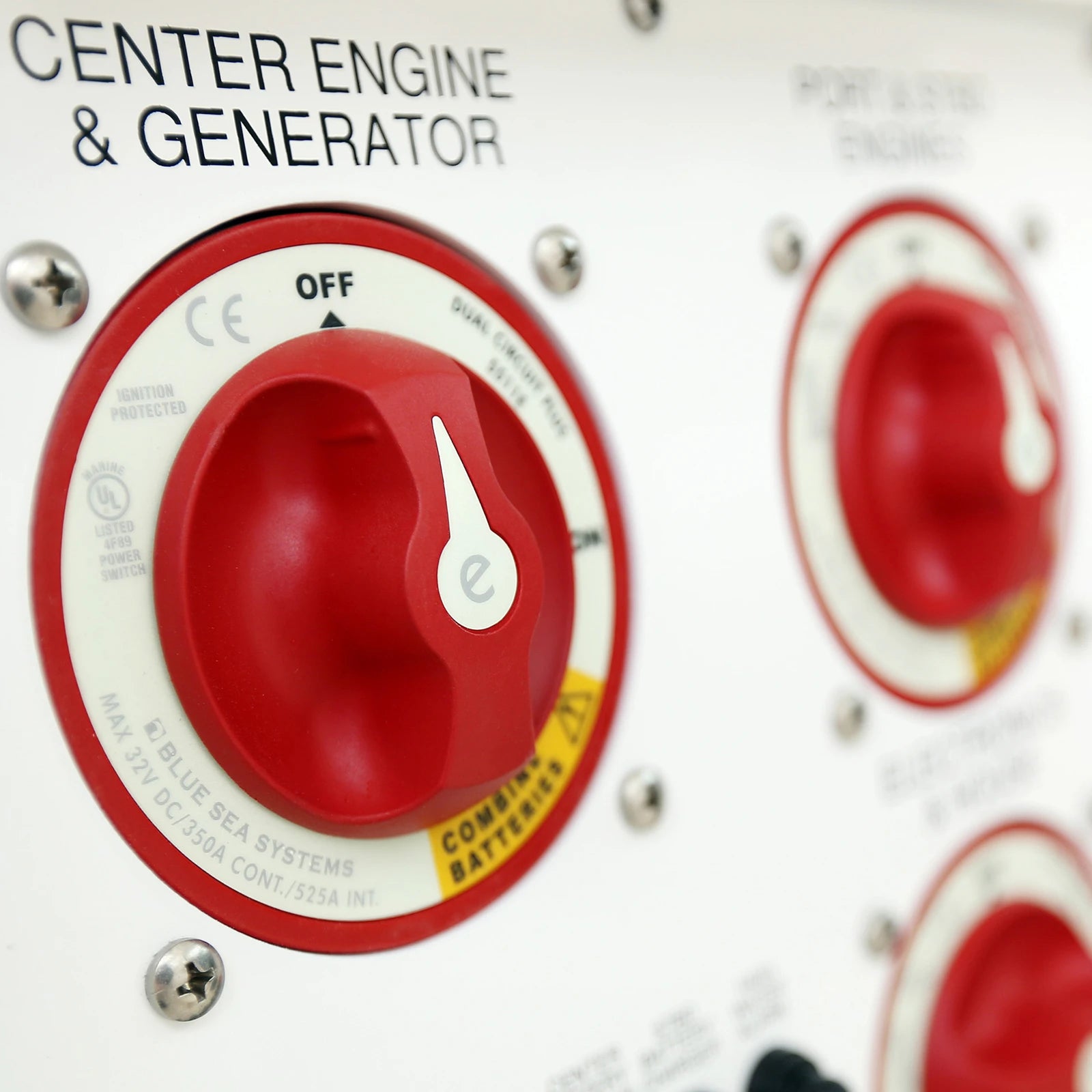 Close-up of a battery switch installed on a labelled marine electrical distribution panel