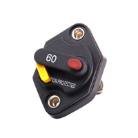 Angled front view of 60A mini panel mount DC circuit breaker showing red trip button and yellow reset lever