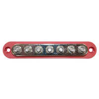 Overhead view of red busbar showing seven tin-plated copper studs and mounting holes