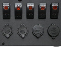 Close-up of rocker switches and waterproof caps on 12V and USB sockets
