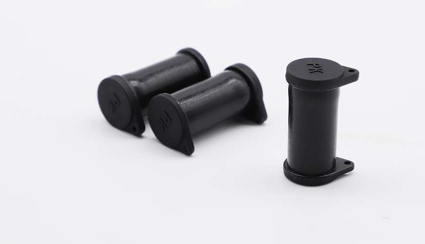 Three black solar connector caps arranged to show side profiles and the closed top with PK marking