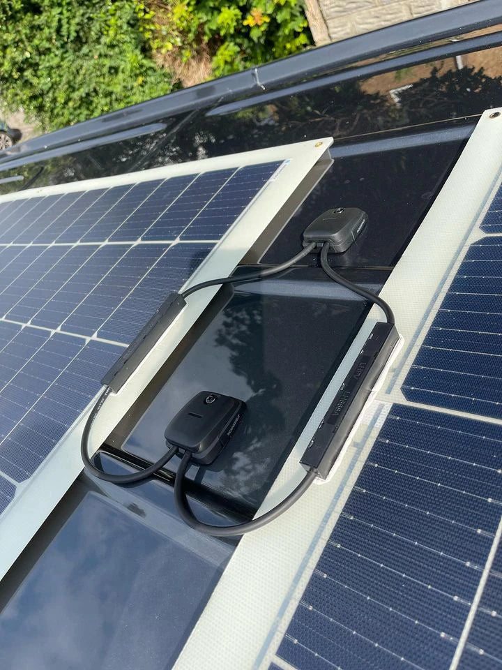 Overhead view of two cable seals routing wires from solar panels on a roof