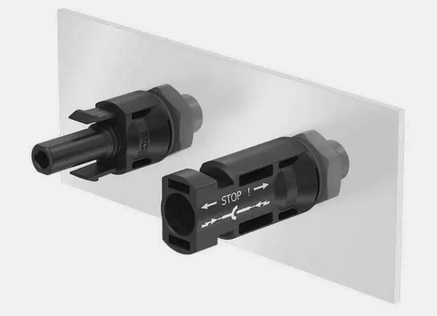 Stäubli MC4 bulkhead connector pair mounted on a panel showing locking tabs and safety markings