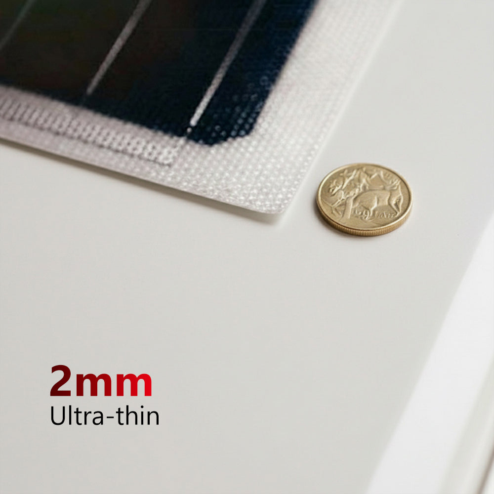 Close-up of a 2mm thick solar panel edge next to a gold coin for scale