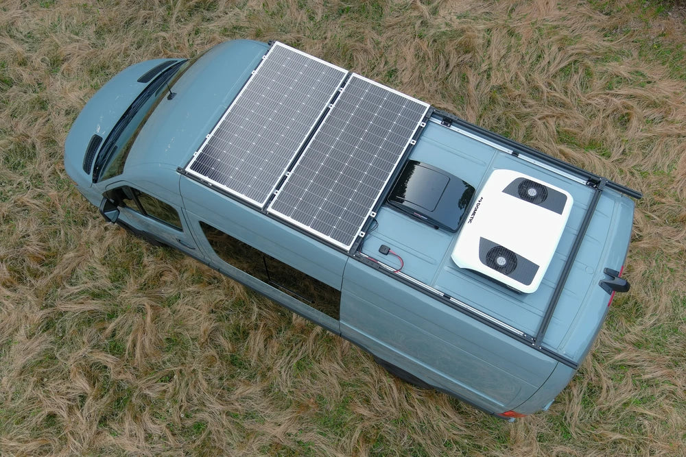 Aerial view of a van roof showing solar panels and black horizontal cable seal