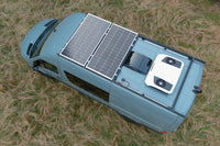 Aerial view of a van roof showing solar panels and black horizontal cable seal