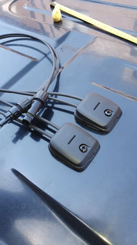 Two Scanstrut cable seals installed on a dark van roof for solar wiring