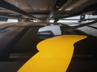 Cable seal installed on a black vehicle roof under a roof rack