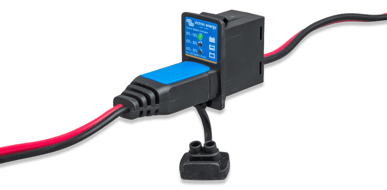 Victron battery indicator panel with status LEDs and charging cable plugged into the interface