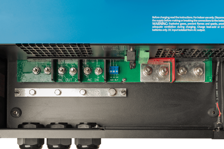 Top-down close-up of labeled internal AC input and output screw terminals