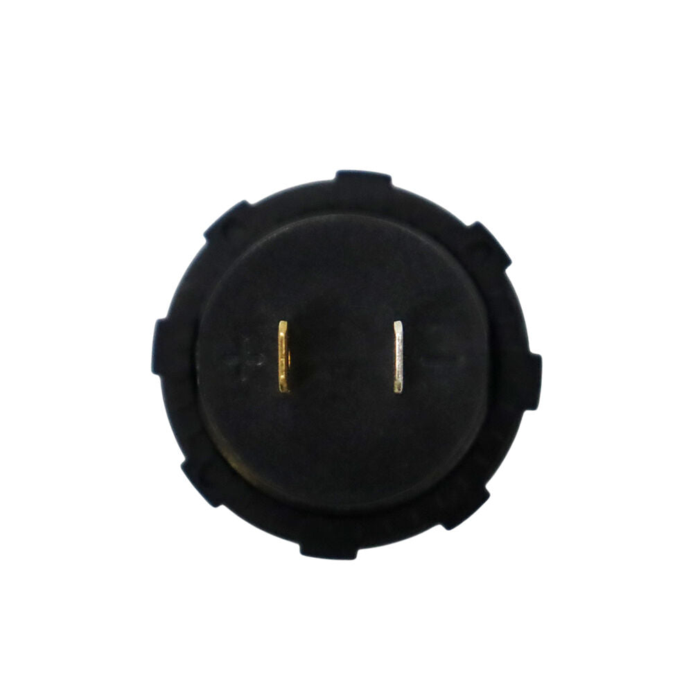 Rear of circular gauge showing positive and negative polarity markings and spade terminals