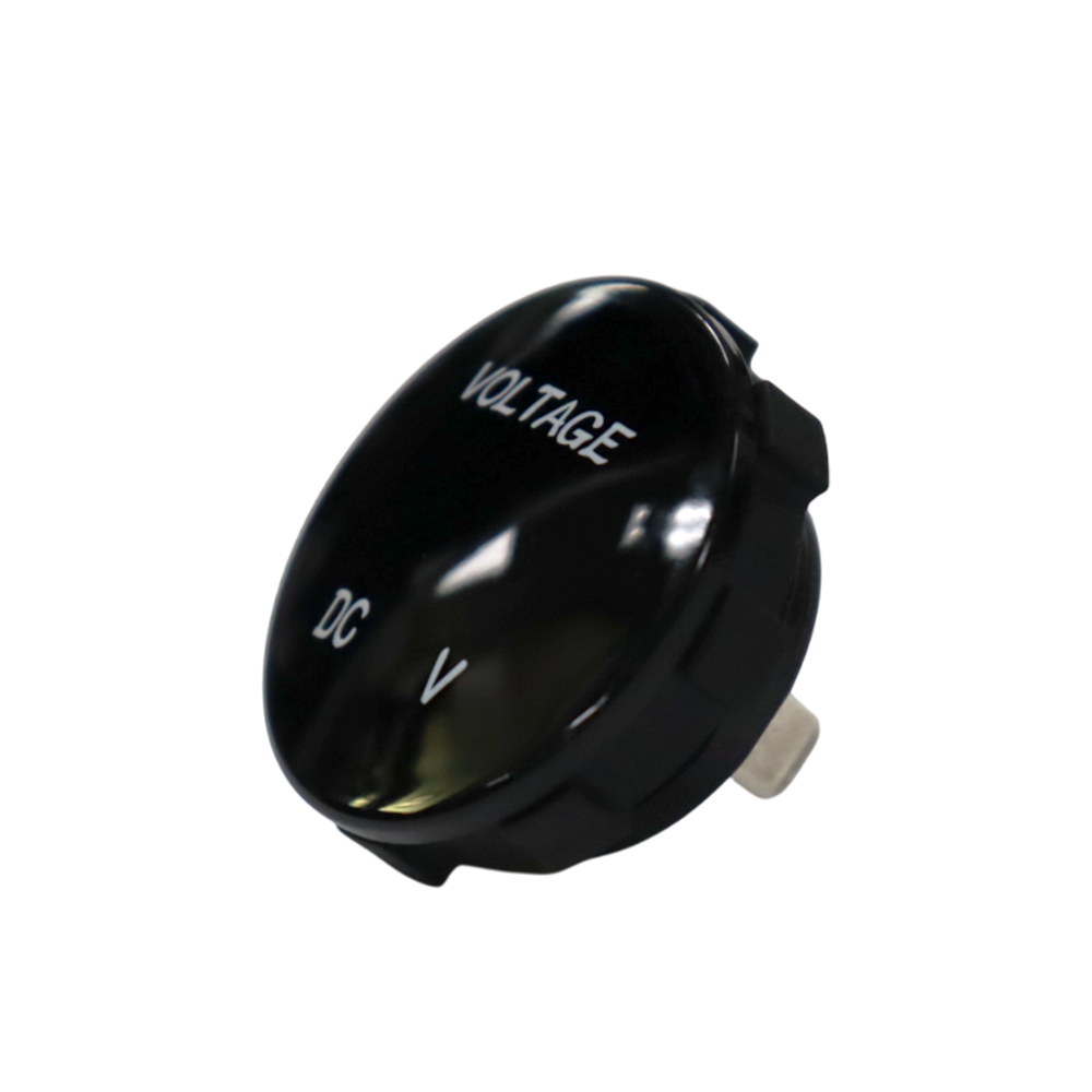 Angled front view of round black voltmeter gauge displaying VOLTAGE and DC V text