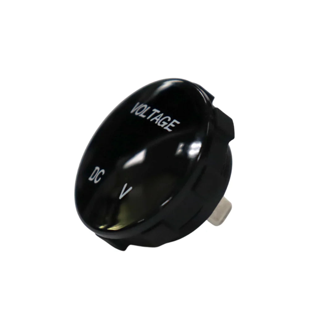 Angled front view of round black voltmeter gauge displaying VOLTAGE and DC V text