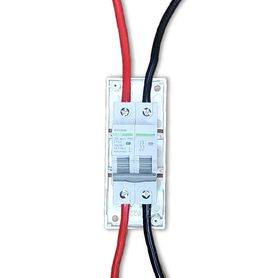 Top-down view of a 2-pole DC circuit breaker connected to red and black solar cables