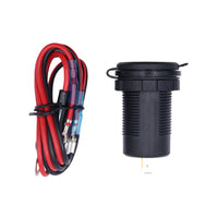 Socket with closed protective cap lying next to the coiled red and black wiring harness